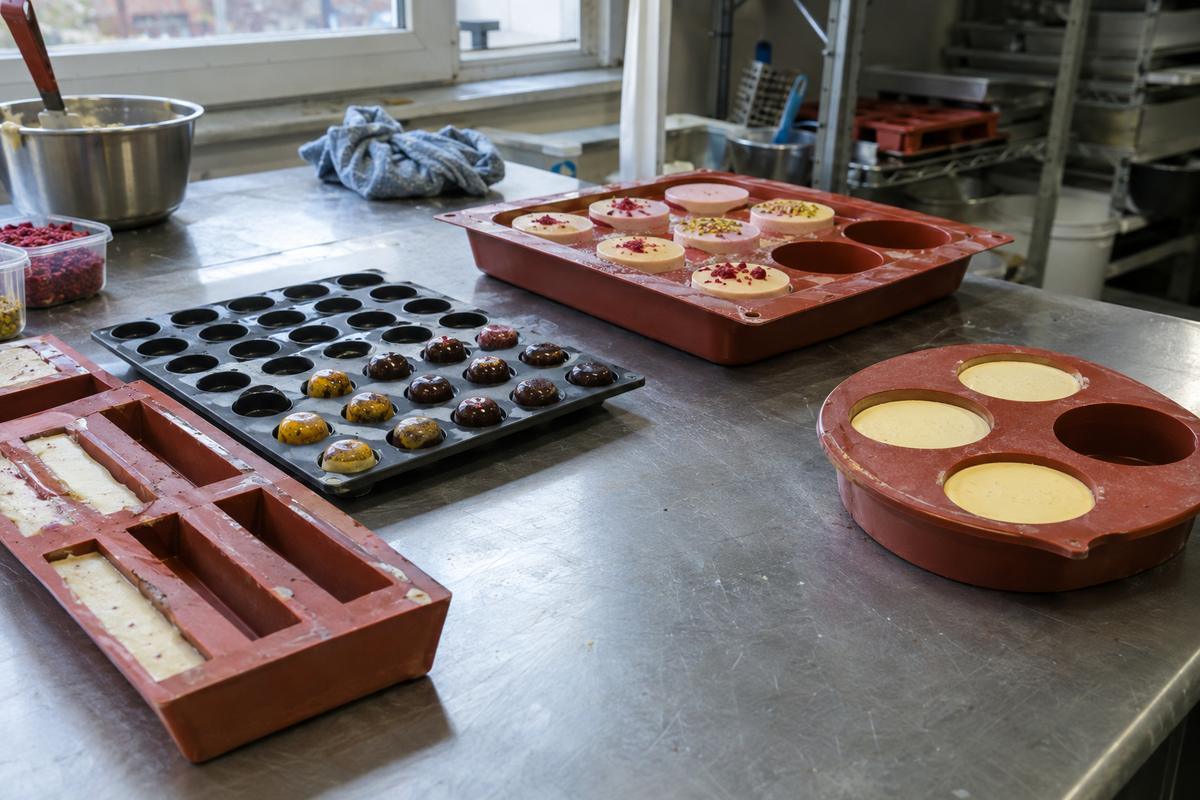 Selection of different silicone food moulds and trays on workshop bench