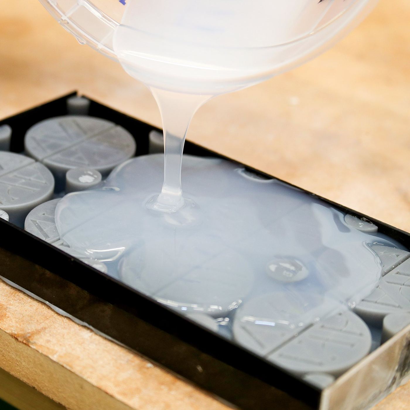 Pouring silicone over master patterns in the TCI workshop
