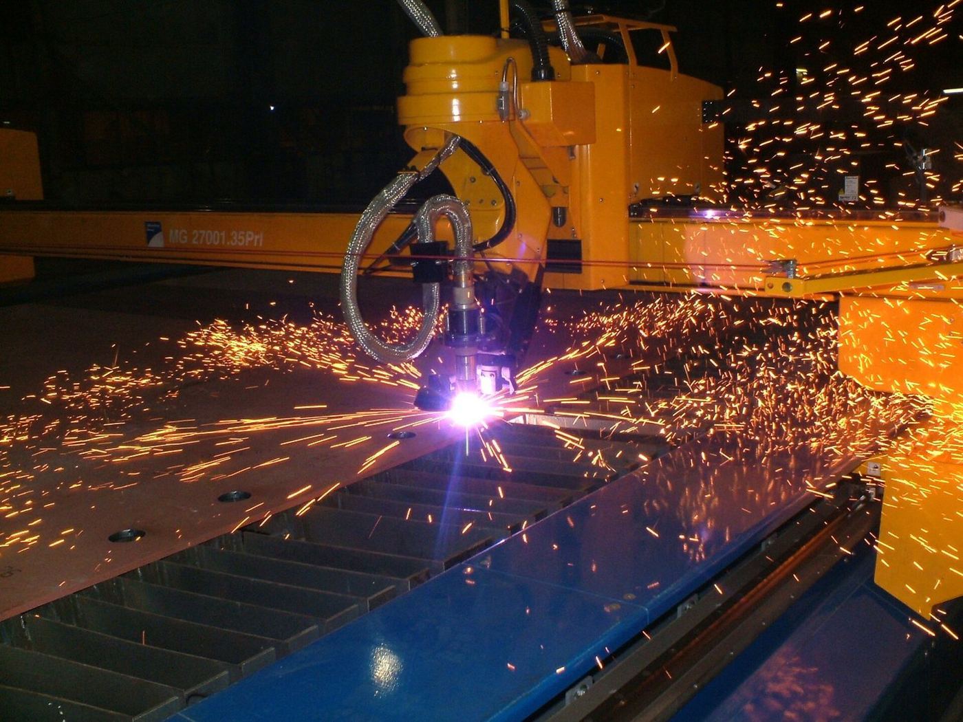 CNC plasma cutting with sparks from the arc.
