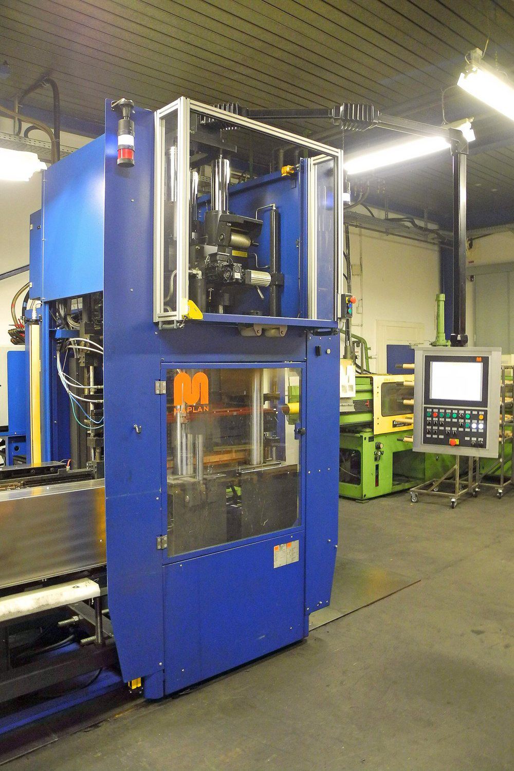 Vertical rubber moulding machine of the type used for injection-transfer moulding.